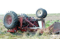 photo of overturned tractor without ROPS